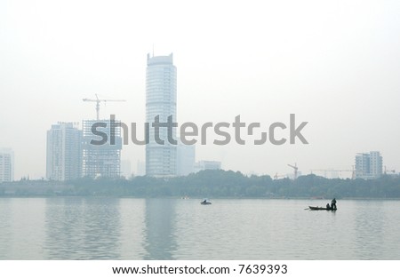 Boats on lake in downtown in fog