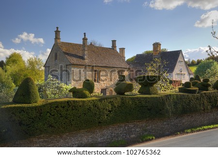 Cotswold House with topiary hedge