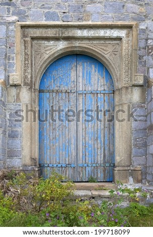 Entrance to castle with large wooden doors.