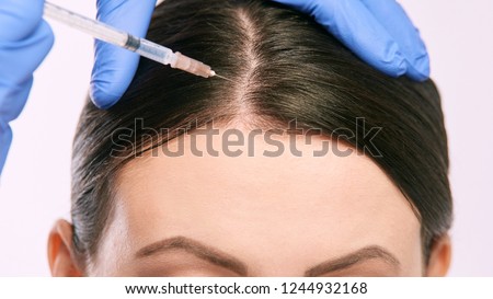 Face needle injection. Young woman cosmetology procedure. Doctor gloves.