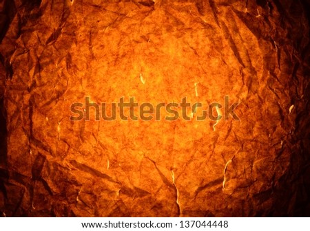Golden brown creased paper background.