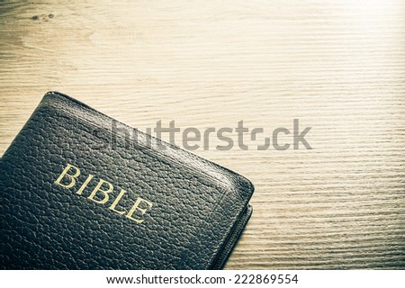 Holy Bible on a wooden table. Background concept with large copy space available. / Bible background