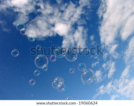 Colorful Soap Bubbles Against Blue Sky Background