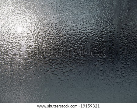 Close-up clear drops of water on window glass surface