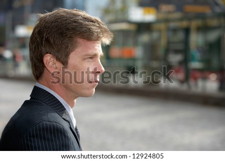 Portrait of man on city street, side profile