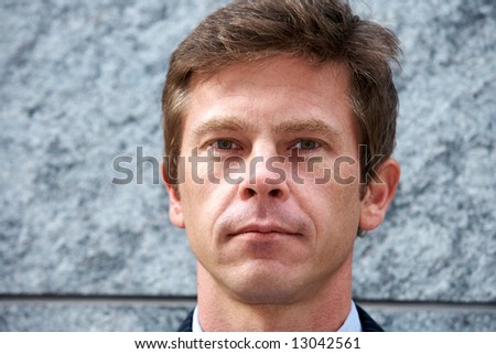 Portrait of man by building wall, frontal close-up