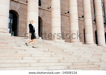 Businesswoman walking down the stairs of building