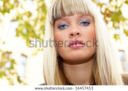 Young woman looking at camera, low angle view, close-up