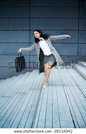Young woman balancing on staircase