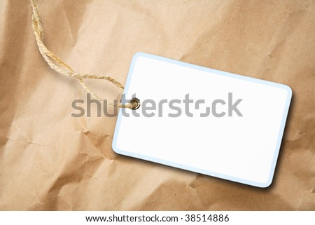 Blank packaging label with cotton string over brown paper
