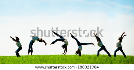 Multiple exposure capturing an African American woman doing a back flip in a beautiful field.