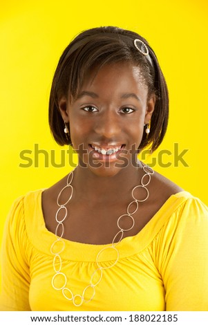 Portrait African American teen wearing yellow with yellow background.