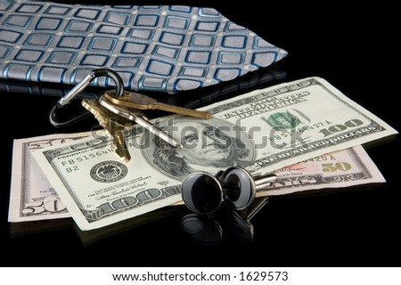 stock-photo-nightstand-with-money-cuff-links-keys-and-a-tie-1629573.jpg