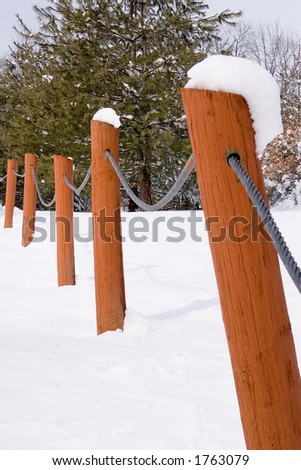 Snow piled on top of fence posts following a Nor\'Easter snowstorm.