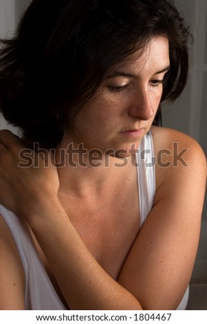Woman with body language and pose indicating deep thought, a tough decision.