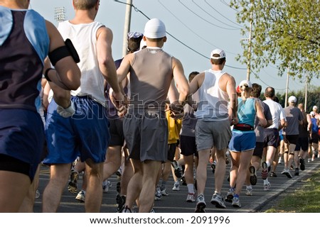 Marathon runners packed tightly together right out of the starting line.