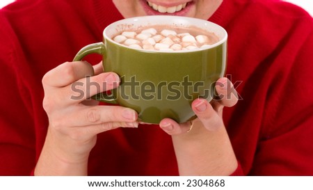 Close-up of an anonymous woman holding a large cup of hot cocoa, about to take a drink.