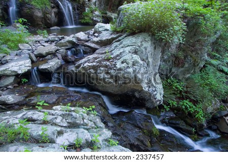 Mountain waterfalls cutting through rocks.