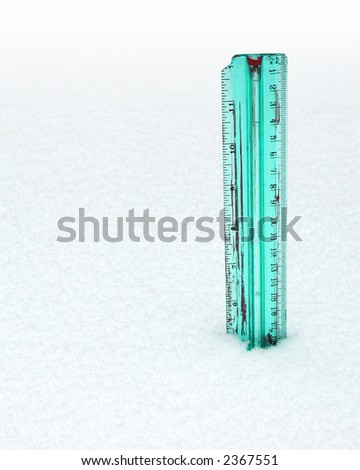 Colorful, old, translucent ruler measures a depth of almost six inches of snow.