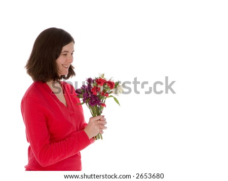 Young brunette woman admires a bouquet of fresh cut flowers. Isolated on white background.