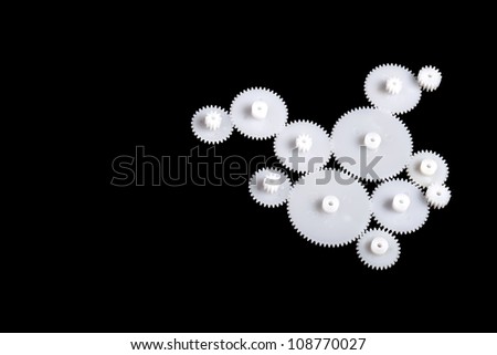 Close up photograph of plastic gears on black background