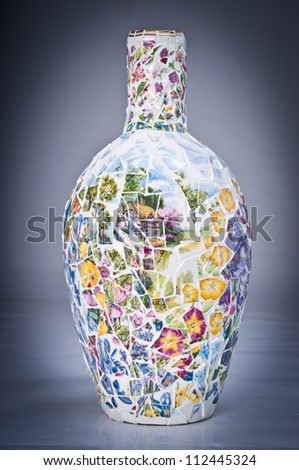 Photo of mosaic vase on a grey background with vignetting
