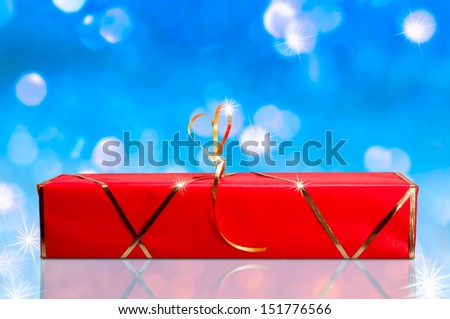 Red and gold gift box on a blue and white background