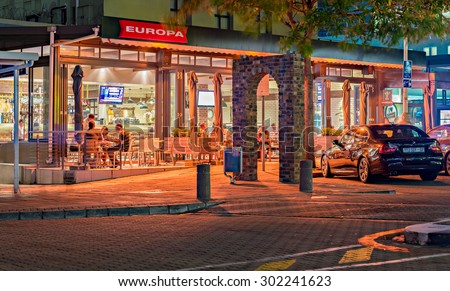 DURBAN, SOUTH AFRICA - JANUARY 26, 2015: Restaurant and people in Umhlanga Rocks Village at night