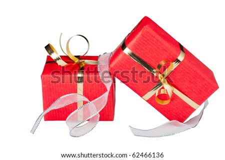 Two red and gold gift boxes with a flowing silver ribbon, isolated on white