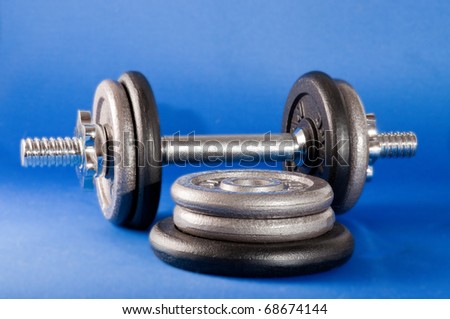 Barbell with free weights on a blue background