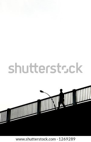 Silhouette Walks on Bridge