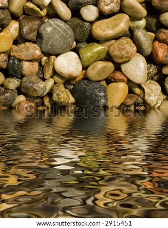 Pebble detail background texture reflected in water