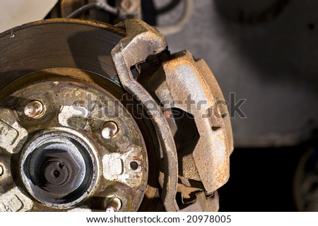 Rusted disc brake and caliper on car