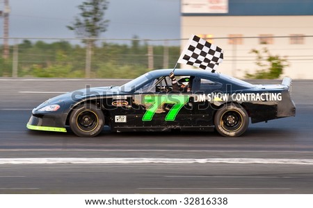 HALIFAX, NOVA SCOTIA - JUNE 26: The #77 car of Colby Smith with the checkered flag at Scotia Speedworld, June 26, 2009 in Halifax, Nova Scotia.