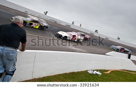 ANTIGONISH, NOVA SCOTIA - JULY 18: Maritime Pro Stock Tour action during the IWK 250 race, July 18, 2009 in Antigonish, Nova Scotia. Here pit crew watches cars during practice.