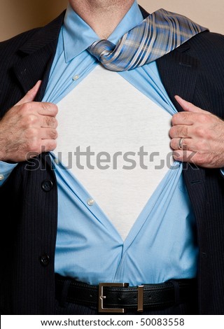 Business man in dark blue suit opens shirt to reveal blank white undershirt. Blank area suitable for your logo or text.