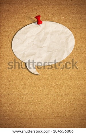 blank speech bubble note paper with push pins on cork board