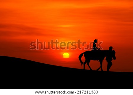 silhouette of a journey on horseback  with sunset