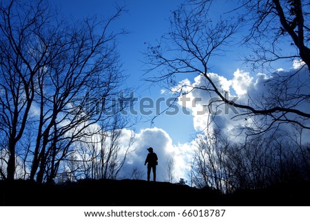 One man stand alone between dry trees