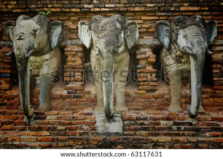 brick old wall that have three molded elephant figure in old Sukothai city , Thailand ,