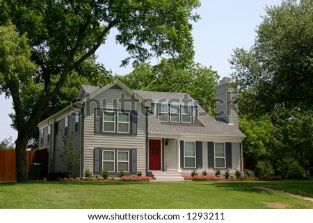  colonial style house with extremely red front door in suburban community
