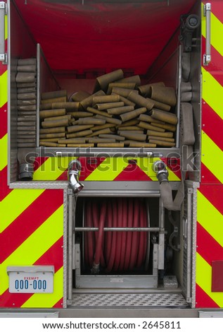 Fire hoses on the back of a fire truck.