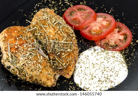 Chicken meat dish / Light food - Plate with baked chicken, sliced ??tomato and white sauce - Closeup