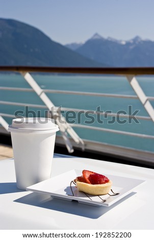 Alaska - Enjoy Haines - Delight With A Strawberry Mini Tart And Hot Drink On The Deck Of Cruise Ship - Travel Destination / Alaska - Delight With A Strawberry Mini Tart And Hot Drink On The Deck