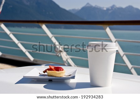 Alaska - Enjoy Haines - Delight With A Strawberry Mini Tart And Hot Drink On The Deck Of Cruise Ship - Travel Destination / Alaska - Delight With A Strawberry Mini Tart And Hot Drink On The Deck