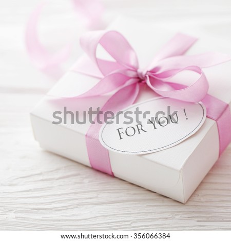 gift box with gift tag. pink satin gift bow