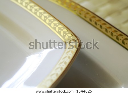 Empty white porcelain plate with gold pattern