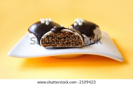 Chocolate cakes - Three sweet chocolate cakes on orange background, close-up