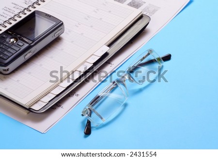 Various office supplies - Documents and mobile phone on blue desk - office equipment