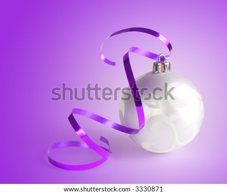Christmas ball series - A traditional Christmas ball with a curly ribbon on a violet background.